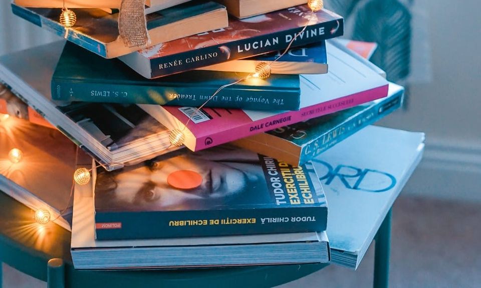 brown wooden framed candle holder on top of books